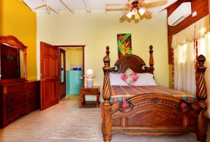 a bedroom with a large wooden bed in a room at Beachfront Cottage in Gros Islet