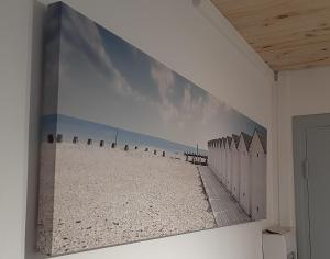 a large painting of a beach on a wall at Le Fontana in Nice