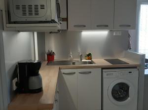 a kitchen with a sink and a washing machine at Le Fontana in Nice