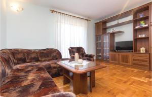 a living room with a couch and a table at Lovely Apartment In Fazana With Kitchen in Fažana