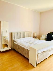 a bedroom with a large bed and a mirror at Best City Apartment in Hannover