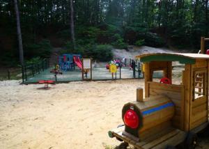a playground with several play equipment in a park at Mobil home 2 in Saint-Chéron