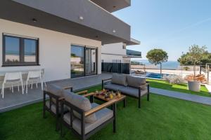 a house with a patio with a table and chairs at Villa Helena in Trogir