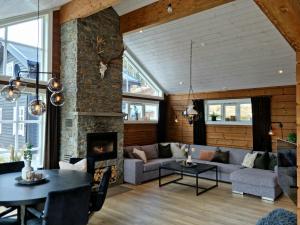 a living room with a couch and a fireplace at Fosskamben Panorama Sogndal in Sogndal