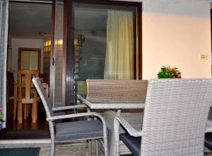 a table and chairs sitting on a porch at Apartment in the heart of Brda wine region, Boris and Darinka Marinič in Dobrovo