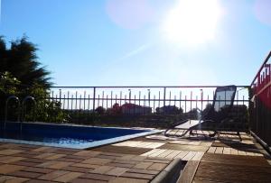 a swimming pool next to a fence with the ocean in the background at Apartment in the heart of Brda wine region, Boris and Darinka Marinič in Dobrovo