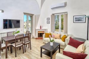 ein Wohnzimmer mit Sofa und Tisch in der Unterkunft DENTECALA 4 in Capri