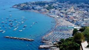 an aerial view of a crowded beach with boats at Casa Giusto Ischia in Ischia