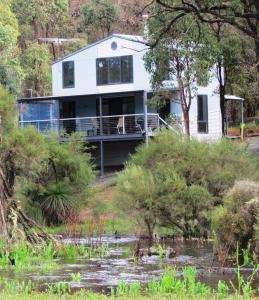 a house on the side of a river at Hidden Grove Retreat in Boyup Brook