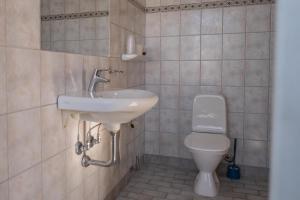 a bathroom with a sink and a toilet at Hotel Viby Kro in Viby