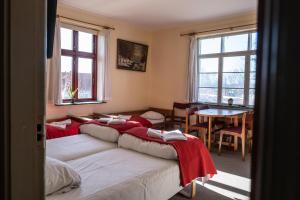 three beds in a room with a table and windows at Hotel Viby Kro in Viby