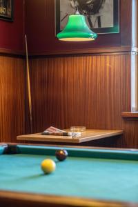 a pool table with a ball and a green lamp at Hotel Viby Kro in Viby