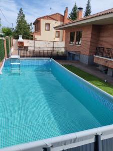 een zwembad met een blauwe omheining bij Aire De Pinares in Coca