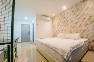 a bedroom with a large bed with a wooden wall at masroom Hotel Kuala Lumpur in Kuala Lumpur