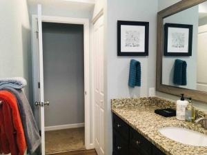 a bathroom with a sink and a mirror at The Aspen - in WPCO at 8488 ft elevation in Woodland Park