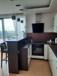 a kitchen with a counter and a stove top oven at Sunset Terrace Apartment in Klaipėda