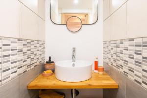 a bathroom with a sink and a mirror at Appartement cocooning proche mer in Carqueiranne +42 photos