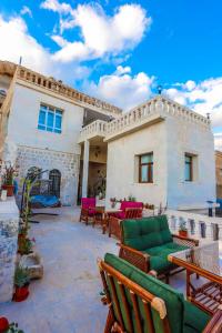 a patio with chairs and tables in front of a house at KASR-I REYYAN in Mardin