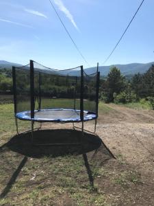 a trampoline in the middle of a field at Velin raj in Soko Banja