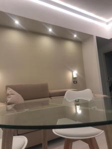 a living room with a glass table and a couch at CasaMare - Luxury Apartment and Pool - Sorrento in Sorrento