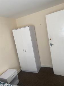 a room with a white cabinet and a door at 8 Challanor road in Yarm