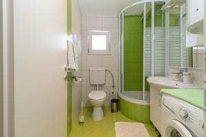 a bathroom with a toilet and a sink at Apartment Roko in Trogir +40 photos