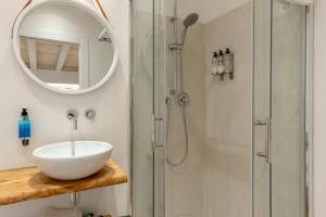 a bathroom with a sink and a shower at In centro da Viola - Eco Design Rooms in Olbia