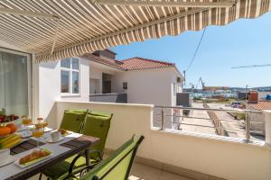 a balcony with a table and chairs with a view at Apartment Roko in Trogir