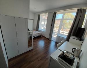 a living room with a white cabinet and a table at Jūros takas in Juodkrantė