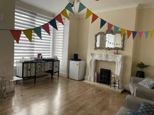 a living room with a fireplace and flags on the wall at South Dene Hotel in Bridlington