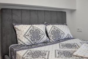 a bed with pillows on top of it at Klaidis house 2 floor in Skiathos Town