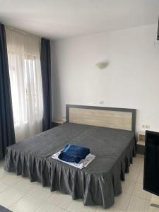 a bedroom with a bed with a blue blanket on it at Luxory Apartament on the Seaside, Gradina beach, St Nicholas Complex in Chernomorets +4 photos