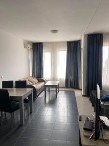 a living room with a couch and a table at Luxory Apartament on the Seaside, Gradina beach, St Nicholas Complex in Chernomorets