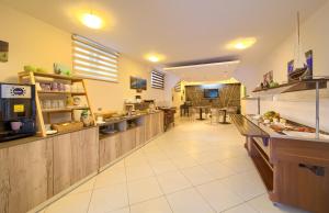 a large kitchen with a long counter in a restaurant at Villa Sunce in Punat