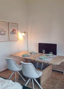 a dining room table with two chairs and a lamp at La Voreta in Villajoyosa