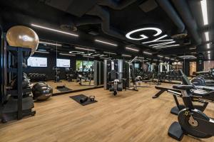 a gym with a lot of treadmills and weights at YOTEL Porto in Porto