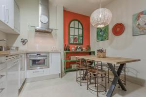 a kitchen with a table and some chairs in it at FAM Sevillian Townhouse in Seville
