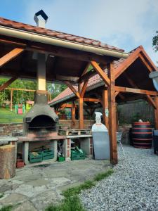 an outdoor kitchen with an outdoor oven in a yard at Domceky Holiday in Liptovský Trnovec