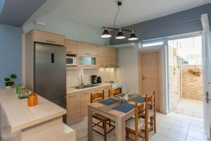 a kitchen with a table and a dining room at Neoria apartment in Chania Town +26 photos