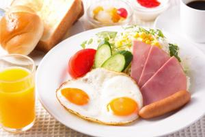 a plate of food with an egg and a salad at Dukes Hotel Nakasu in Fukuoka