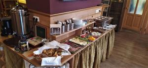 a buffet of food on a table in a restaurant at Harrachovská Hacienda in Harrachov