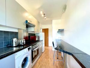 a kitchen with a washer and dryer at No2326 Tree-Hole in Northolt