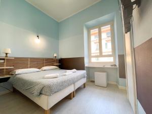 a bedroom with a large bed and a window at Prati Boutique Suites in Rome