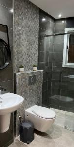 a bathroom with a toilet and a sink and a shower at Tiwaline Tarsime App A in Sidi Ifni +13 photos