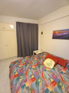 a bedroom with a bed with a hat on it at Old Town apartment 2 in Larnaca