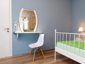 a childs room with a white crib and a mirror at Villa Agrithea in Kissamos