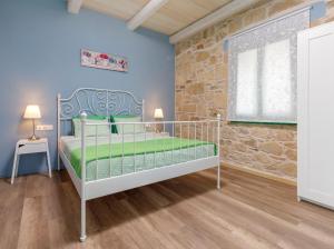 um quarto com uma cama e uma parede de pedra em Villa Agrithea em Kissamos