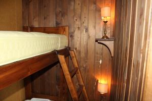 a bedroom with a bunk bed and two lights on the wall at casa Luca Prato Verde 1 in Pescasseroli