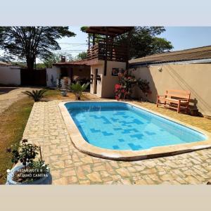 a swimming pool in the backyard of a house at Pousada Flor da Chapada in Chapada dos Guimarães