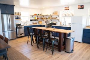 a kitchen with blue cabinets and a wooden table and chairs at BaseCamp 37° in Kanab